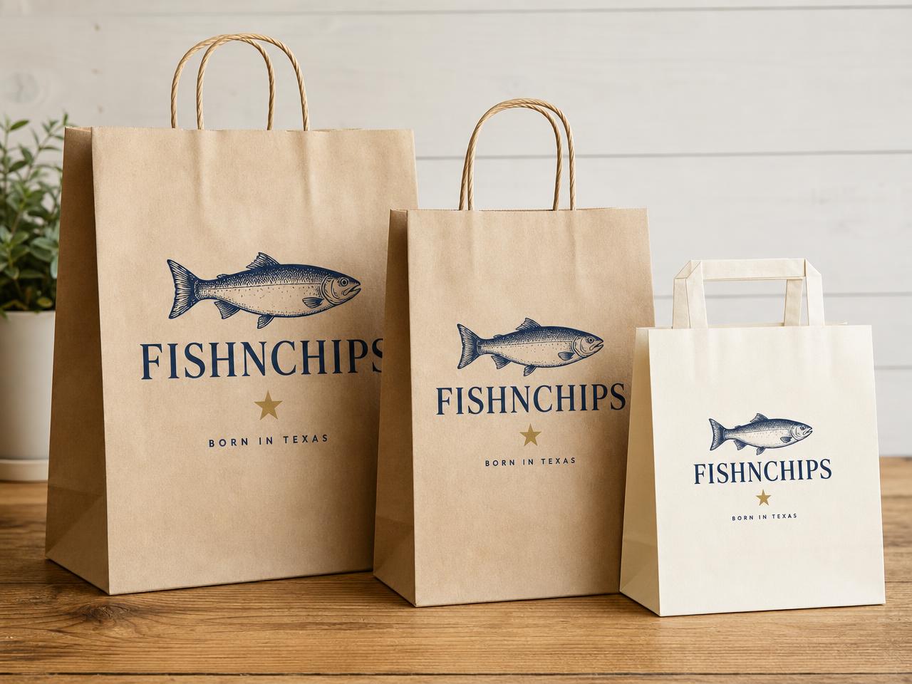 To-go paper bags printed with the FishNChips fish emblem in navy on kraft and cream stock